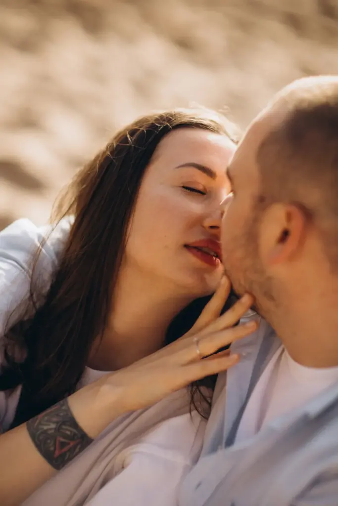 Close portrait of a couple kissing on the beach near Sintra