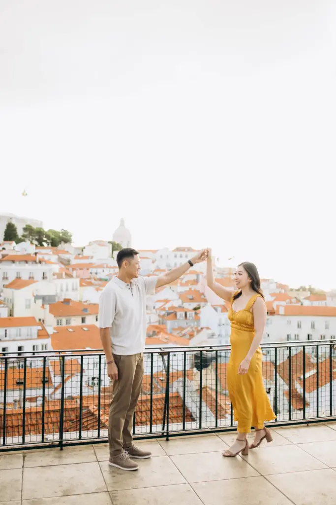Couple dancing at the Portas do Sol viewpoint above Alfama