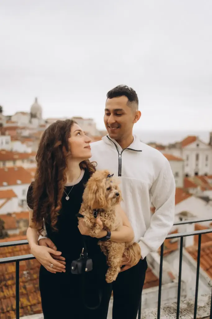 Couple with their dog above the rooftops of Alfama