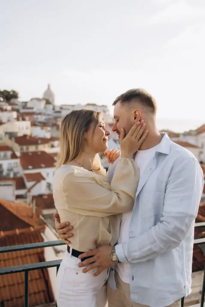 Couple face to face above the rooftops of Alfama
