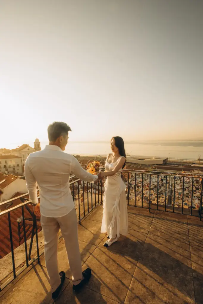 Couple facing each other on a viewpoint terrace above the Tagus