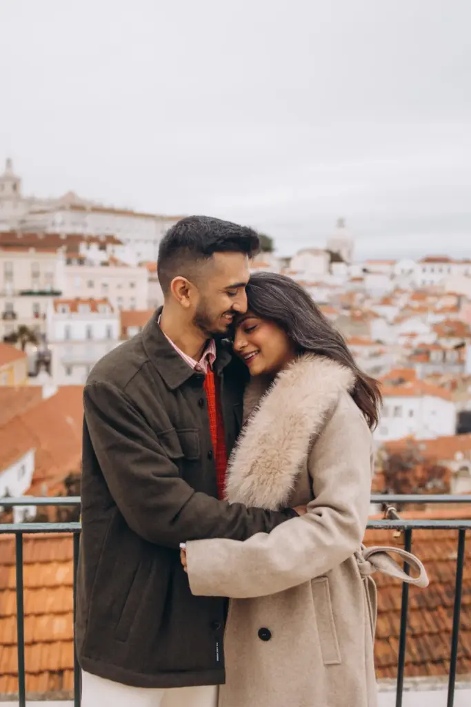 Couple hugging at the Alfama viewpoint in winter