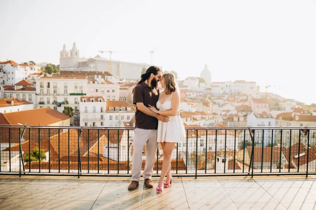 Couple kissing at the Portas do Sol viewpoint over Alfama