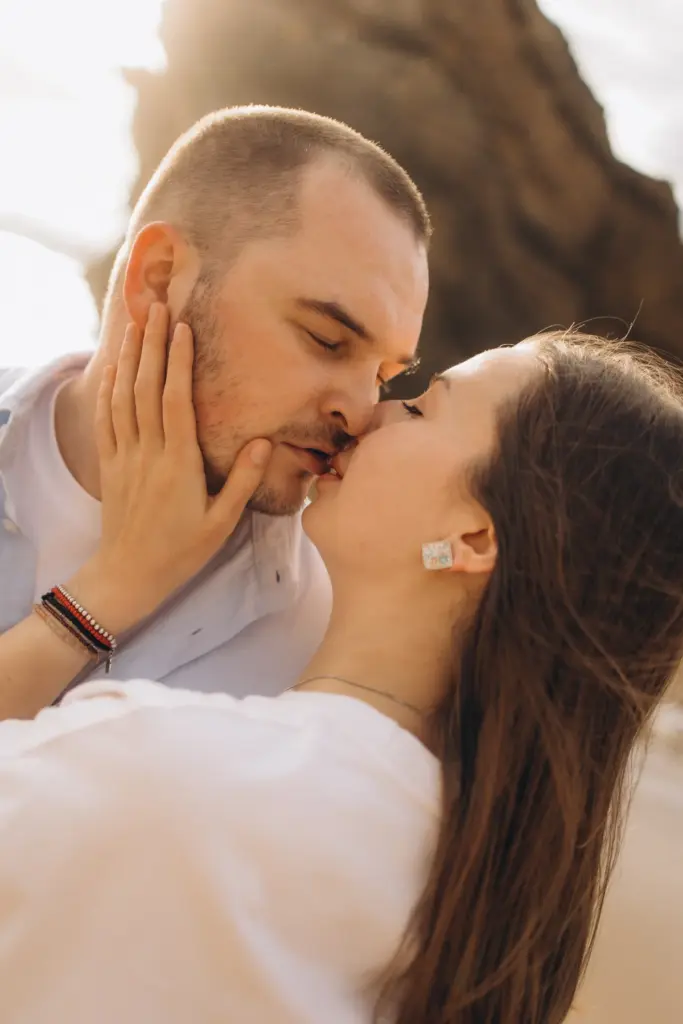 Couple kissing on Praia da Adraga