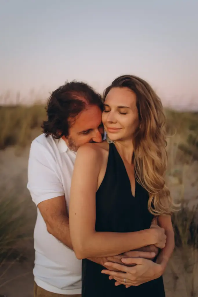 Man embracing his partner in the dunes at Costa da Caparica
