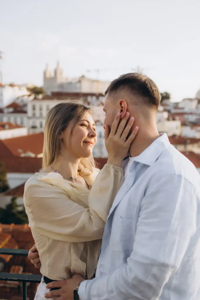 Woman touching her partner's face at an Alfama viewpoint