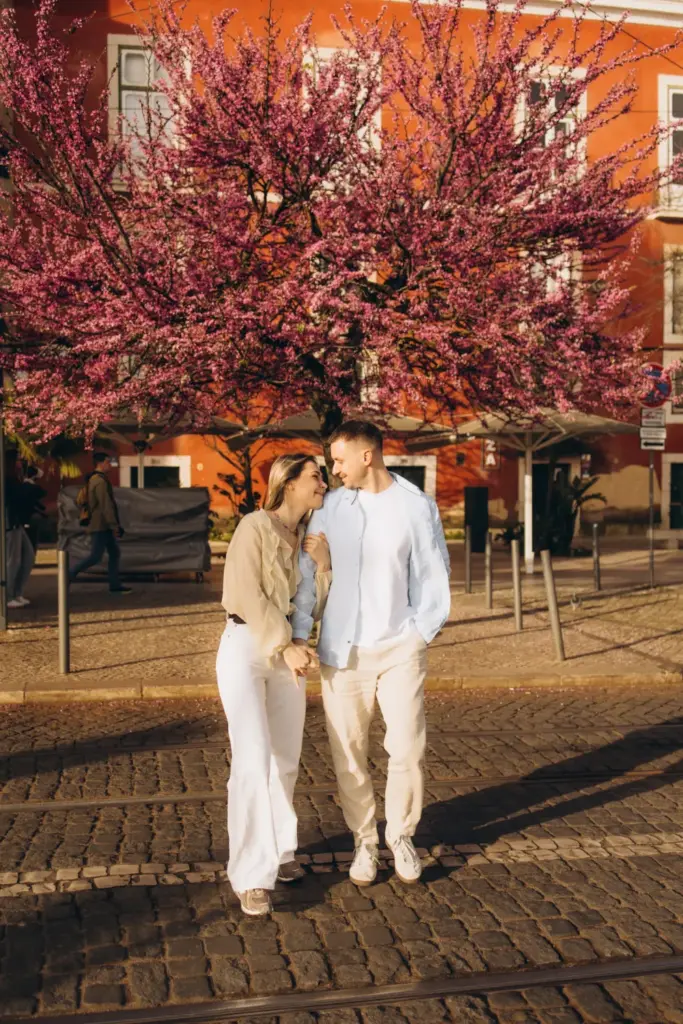 Couple under a blossoming tree on a Lisbon square