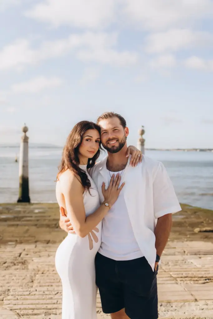 Engaged couple by the river at Cais das Colunas