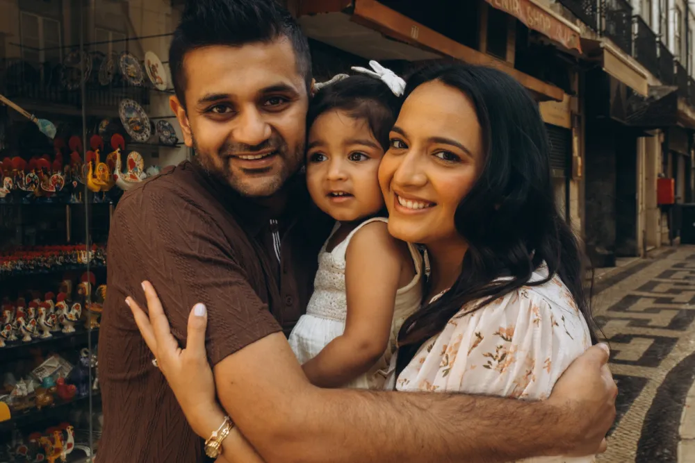 Family hug in a Lisbon shop doorway
