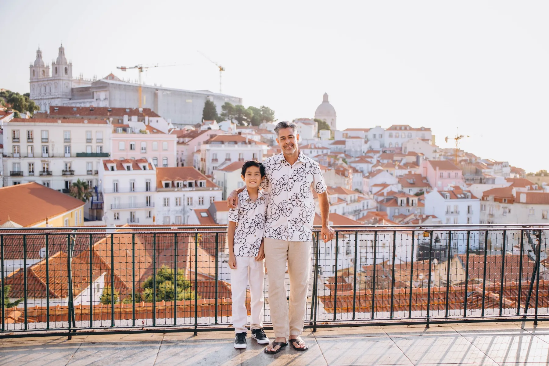 Family at an Alfama viewpoint at sunrise