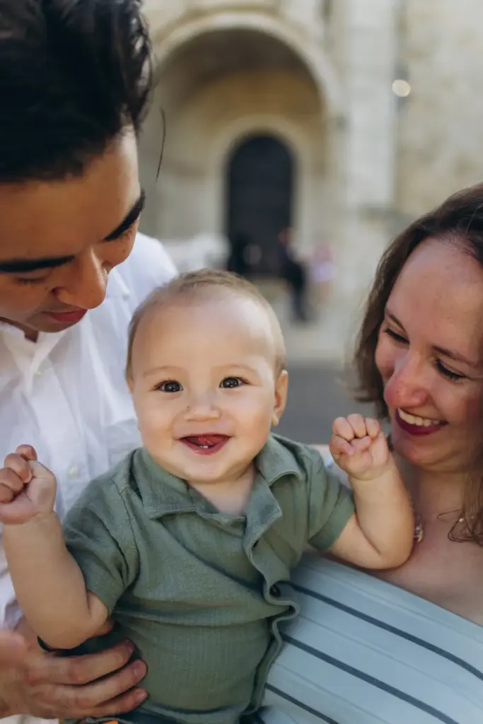 Baby laughing between his parents