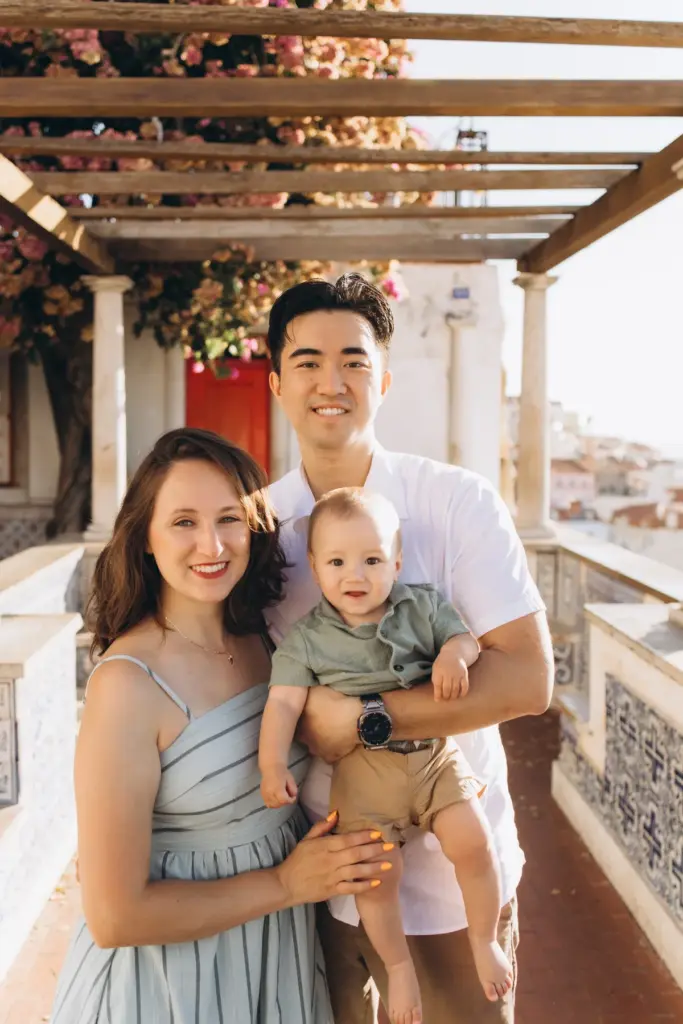 Family with their baby under the bougainvillea pergola at Santa Luzia