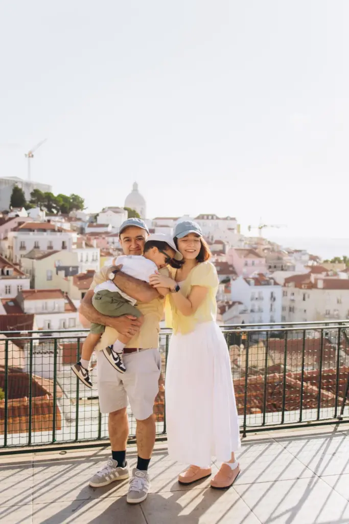 Father lifting his son at an Alfama viewpoint