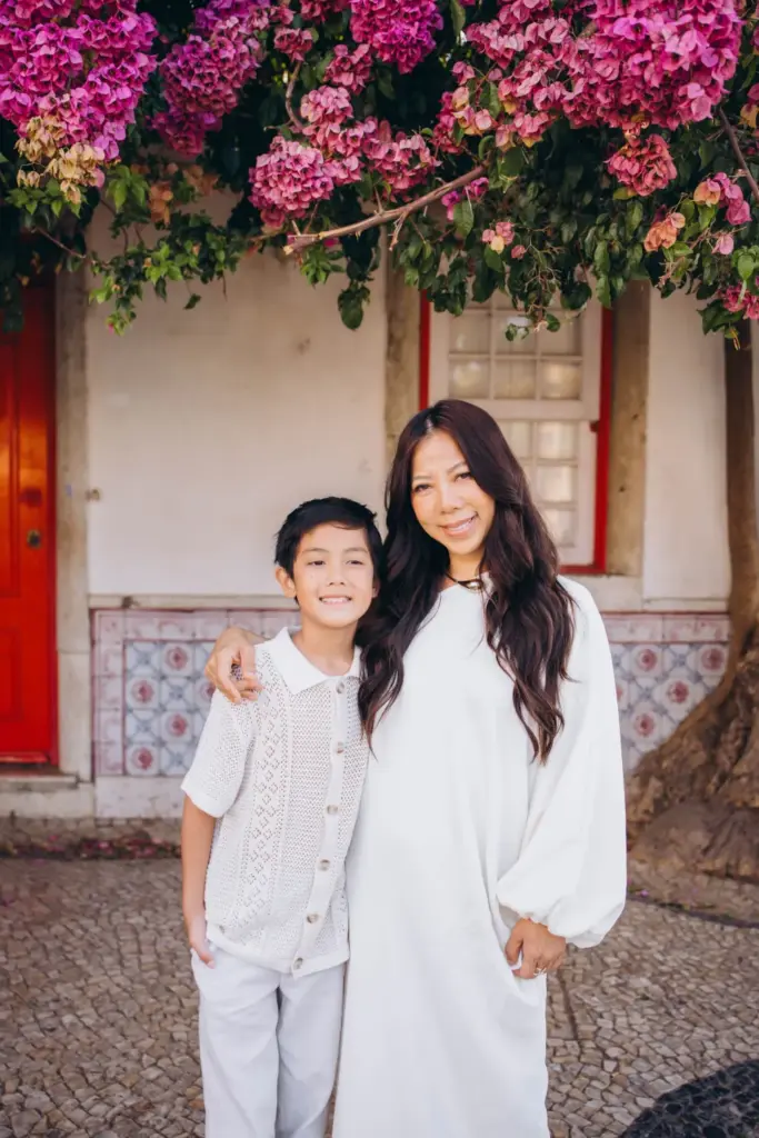 Mother and son by a red door in Alfama