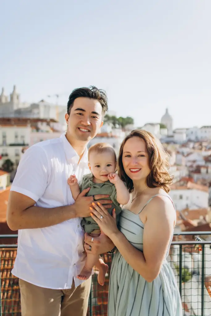 Parents holding their baby at the Portas do Sol viewpoint