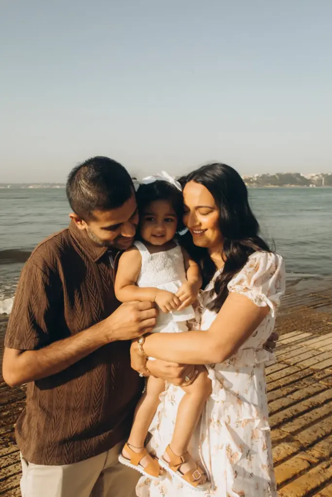 Parents holding their toddler on the riverfront