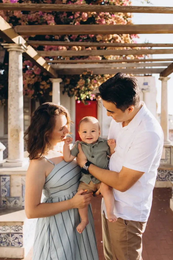 Parents laughing with their baby on the tiled terrace of Santa Luzia
