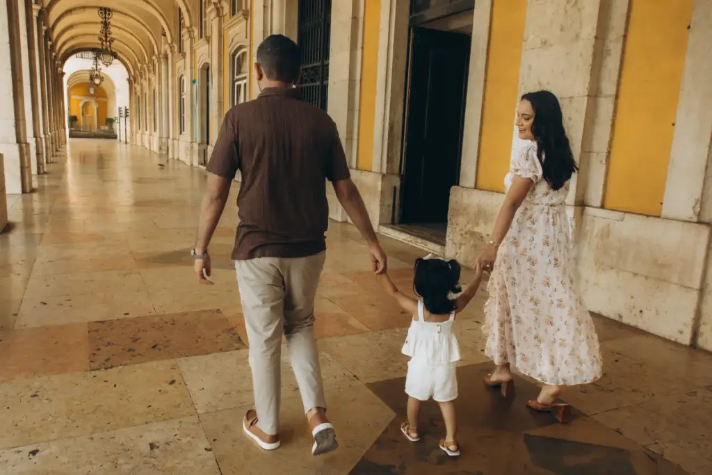 Family walking under the arcades of Praça do Comércio