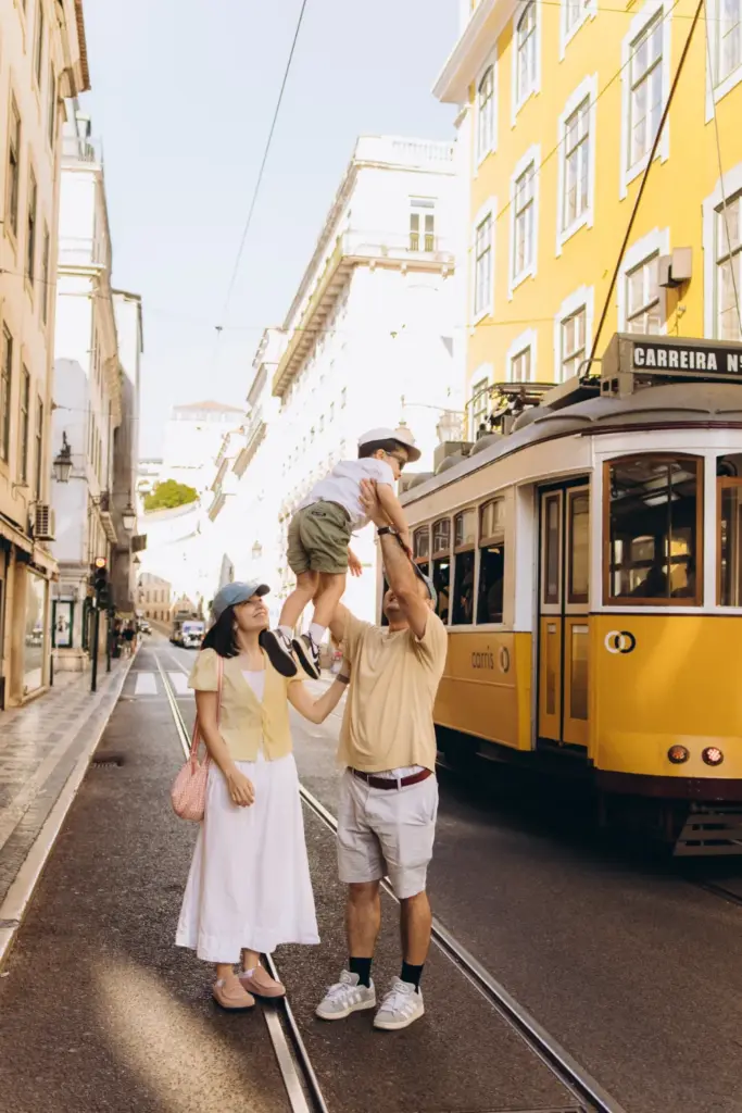 Family walking past a yellow tram