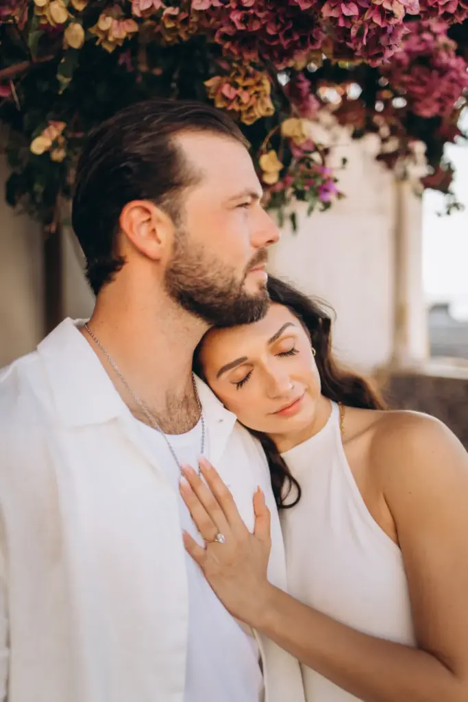 Newly engaged couple under bougainvillea