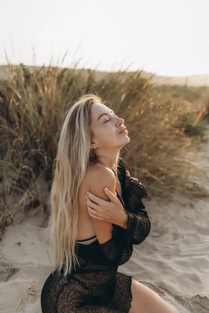 Woman in the dune grass by the ocean