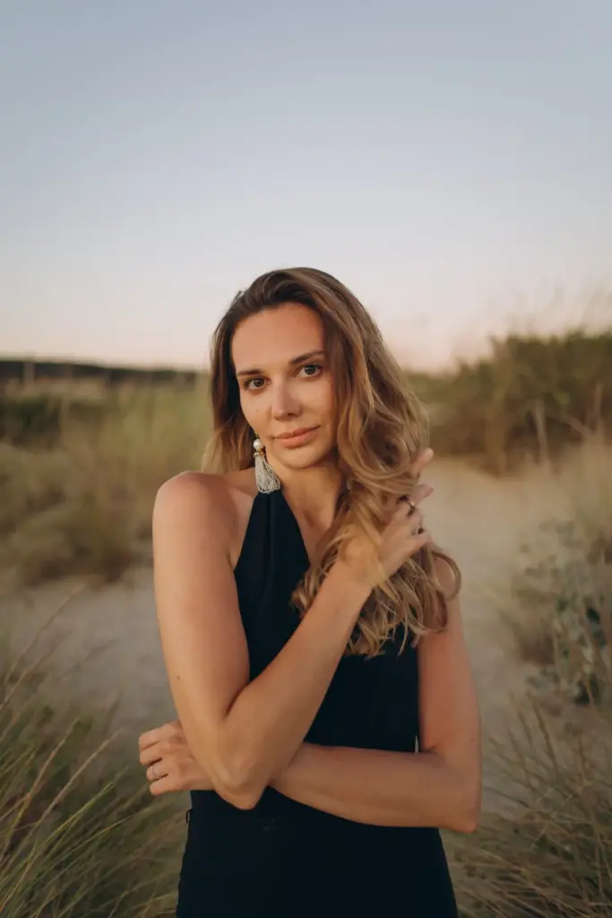 Portrait of a woman among the grassy dunes of Costa da Caparica