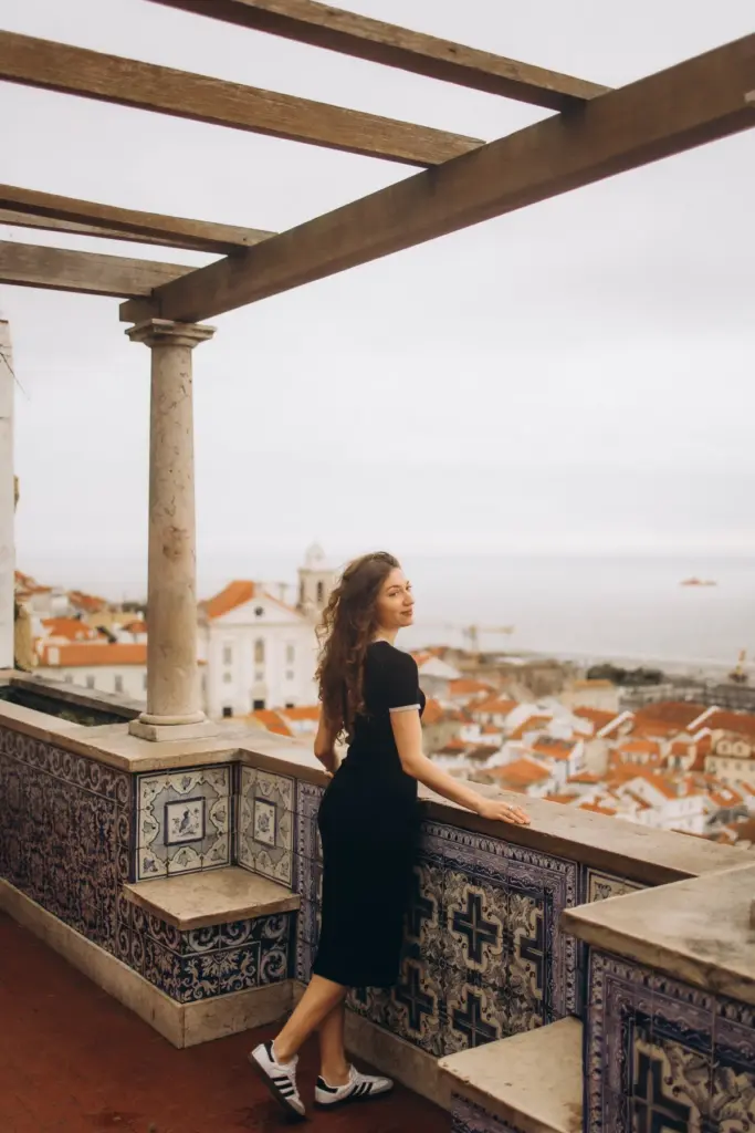 Woman looking out over Alfama from the Santa Luzia terrace