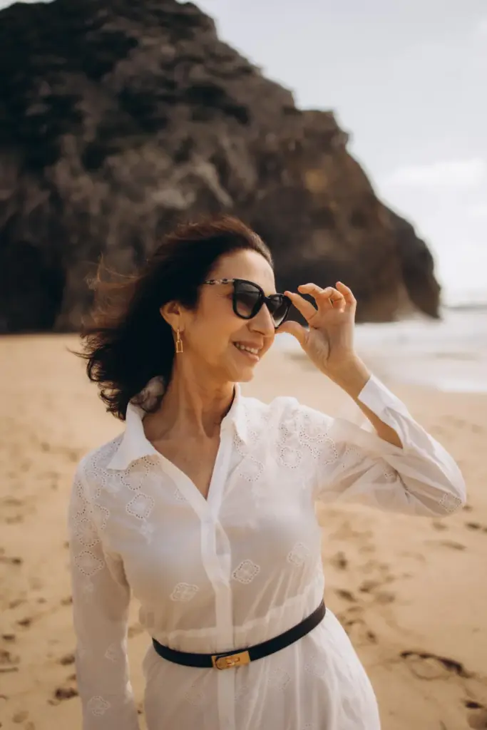 Woman on Praia da Adraga below the cliffs