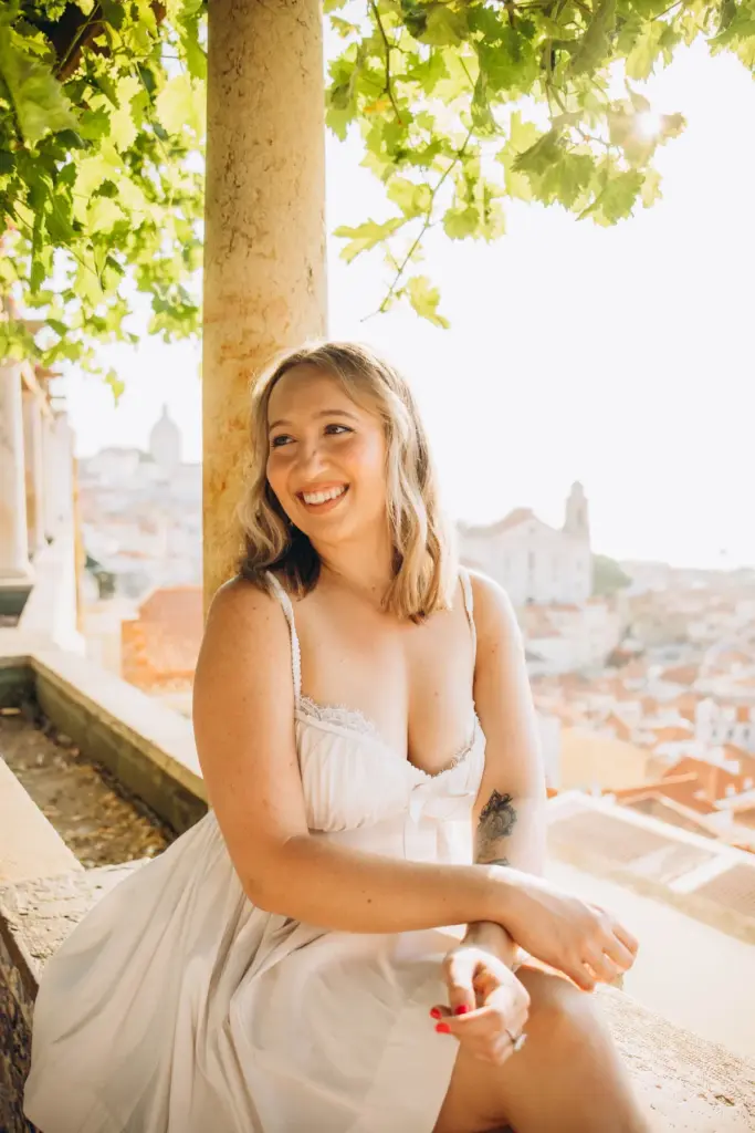 Woman smiling on the tiled bench at Santa Luzia viewpoint