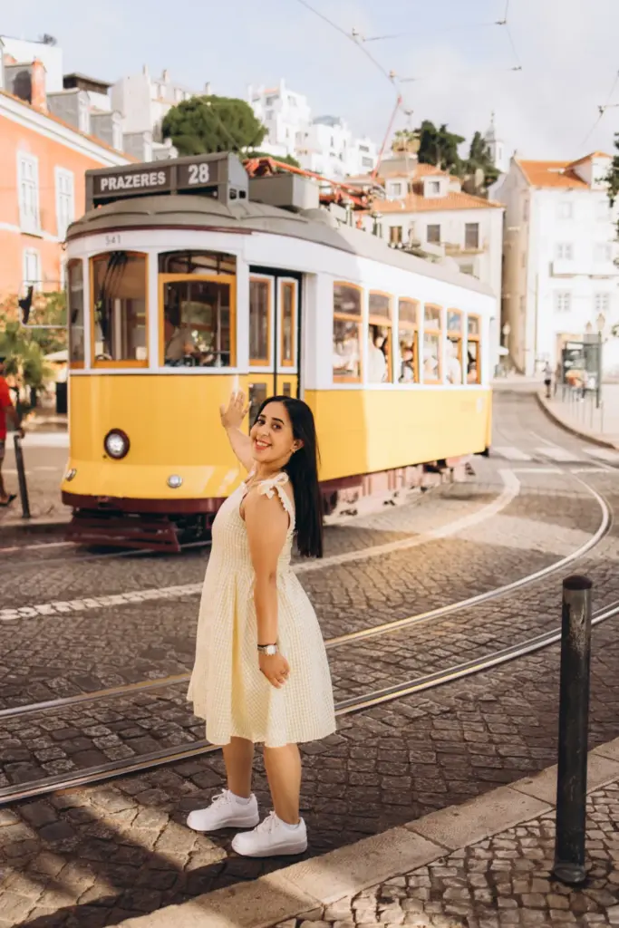 Woman by a yellow tram in Alfama