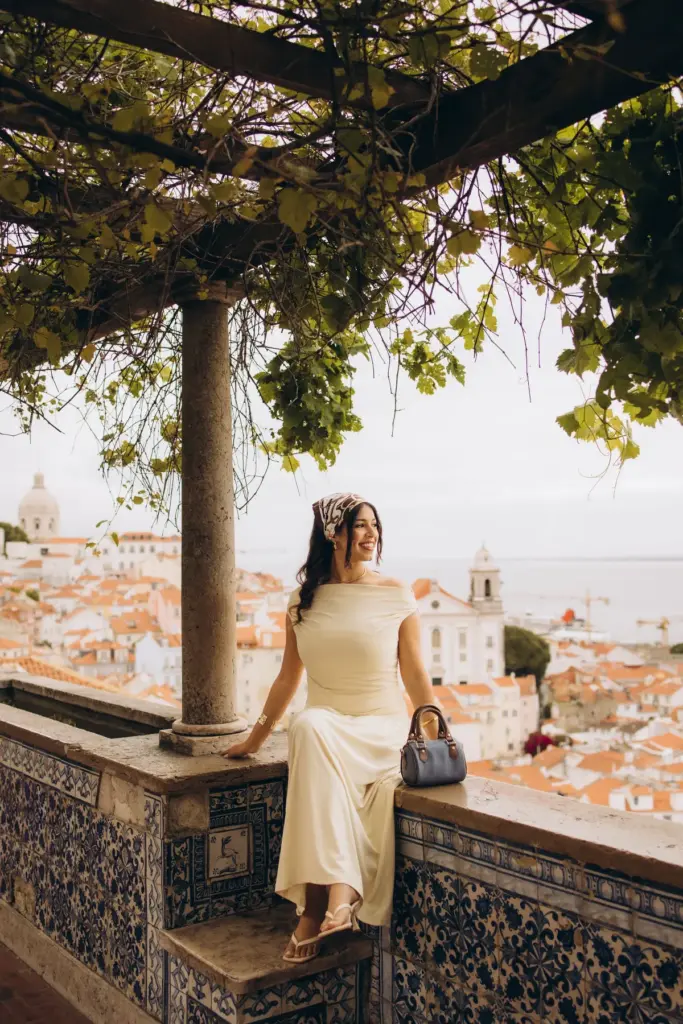 Woman sitting on the tiled wall under the pergola at Santa Luzia