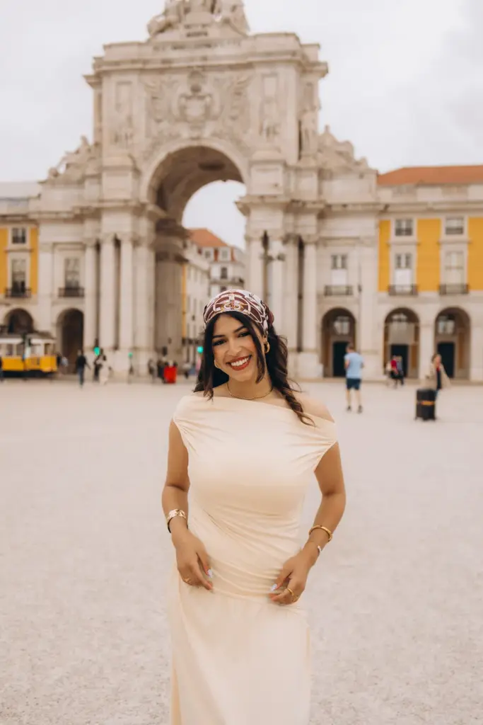 Woman standing in front of the Rua Augusta Arch at Praça do Comércio