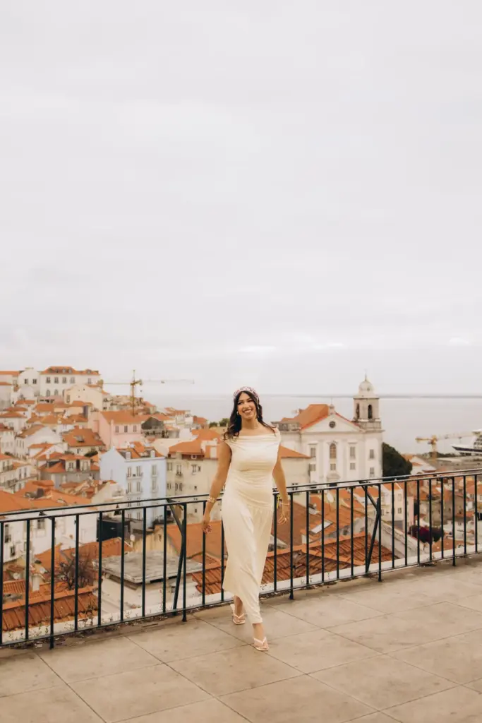 Woman walking across the Portas do Sol viewpoint