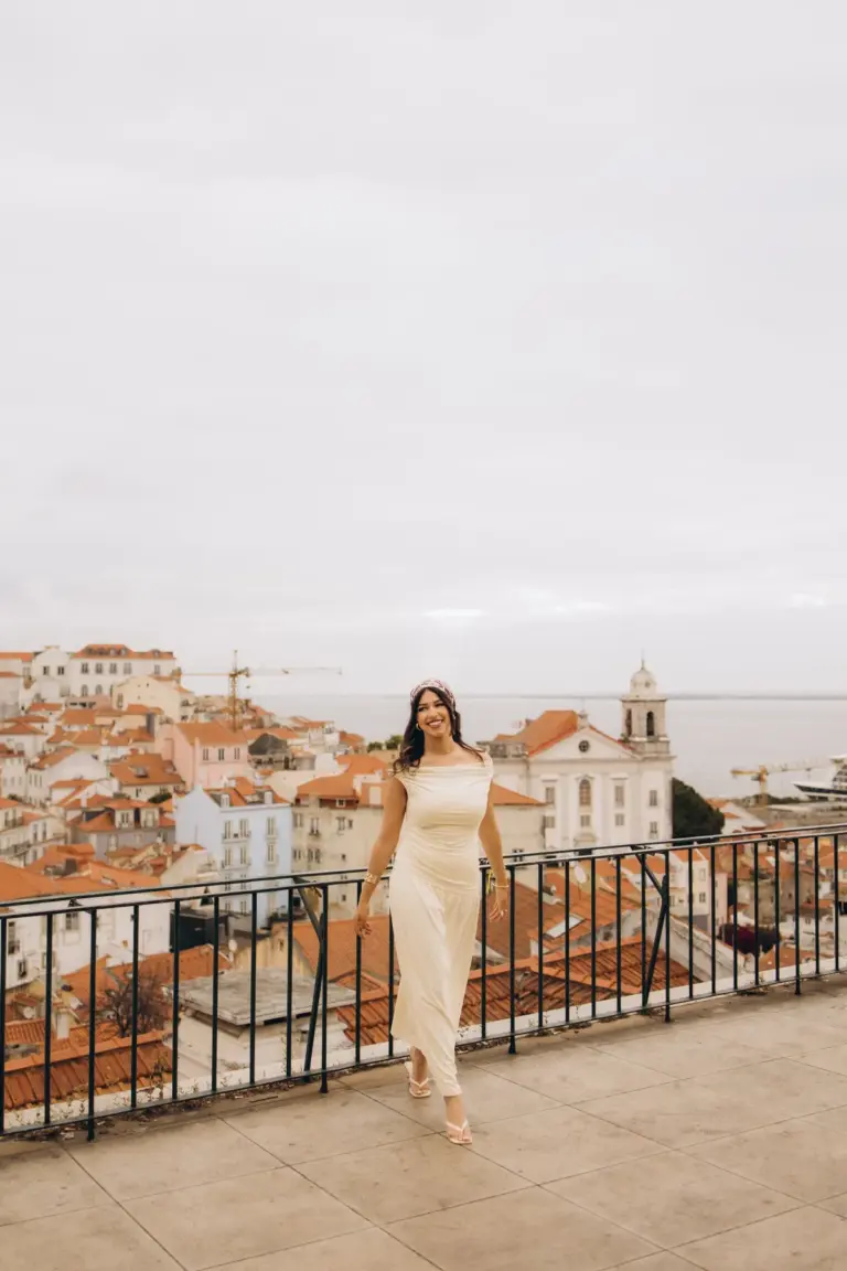 Woman walking across the Portas do Sol viewpoint