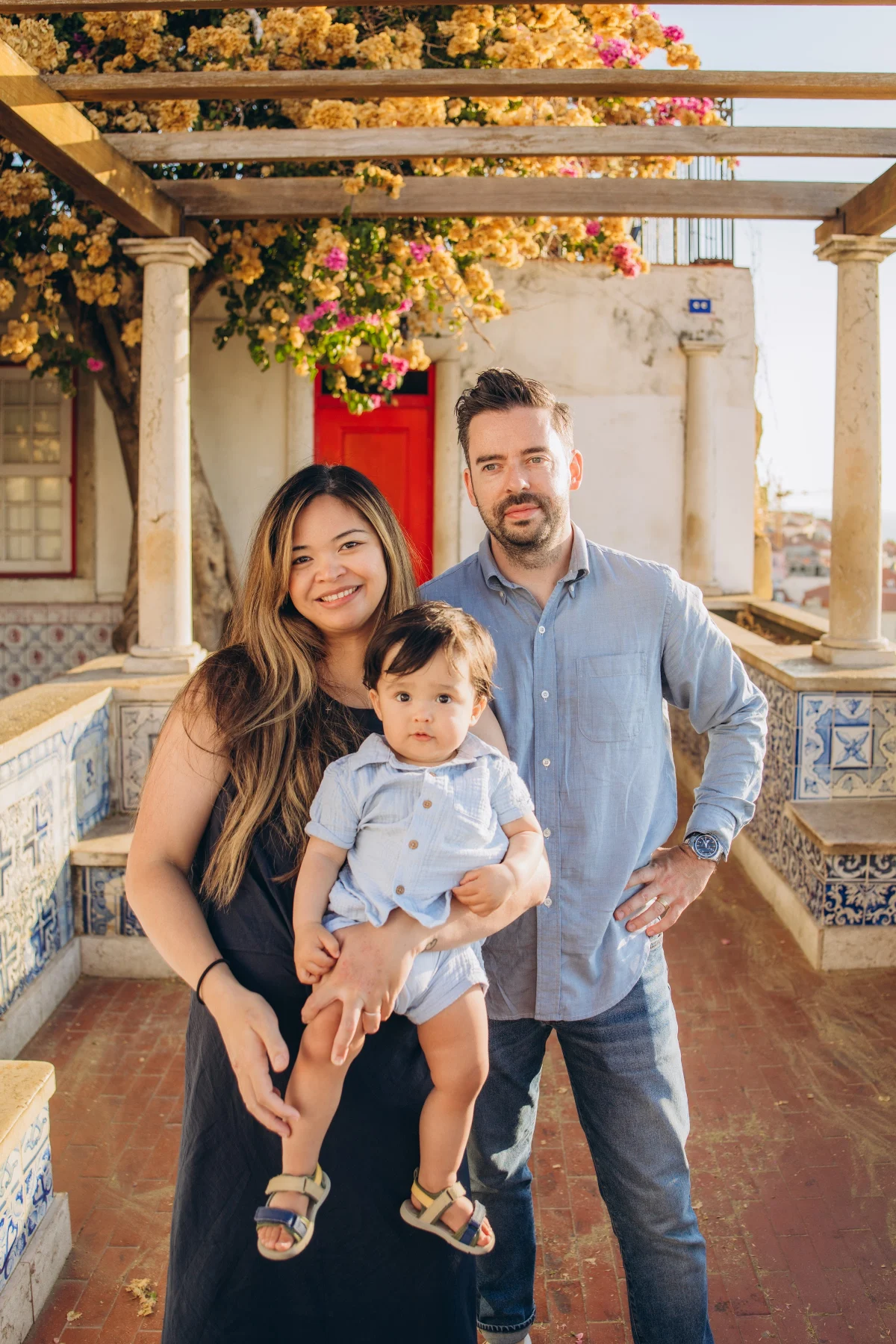 Family under the bougainvillea pergola at an Alfama viewpoint