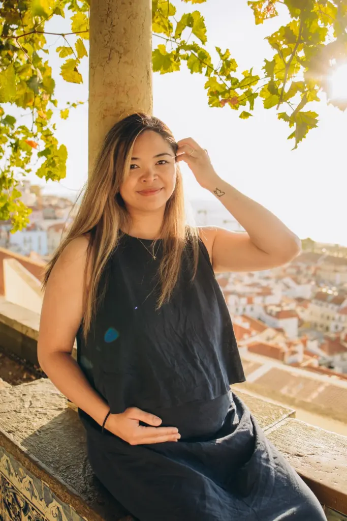 Mum-to-be sitting under a tree at an Alfama viewpoint